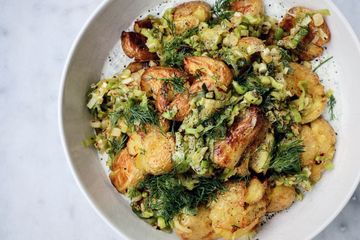 Crispy smashed potato salad with herby yoghurt and brown butter caramelized leeks