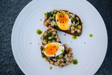 Not-yet-hummus on fried toast with jammy eggs and parsley garlic oil